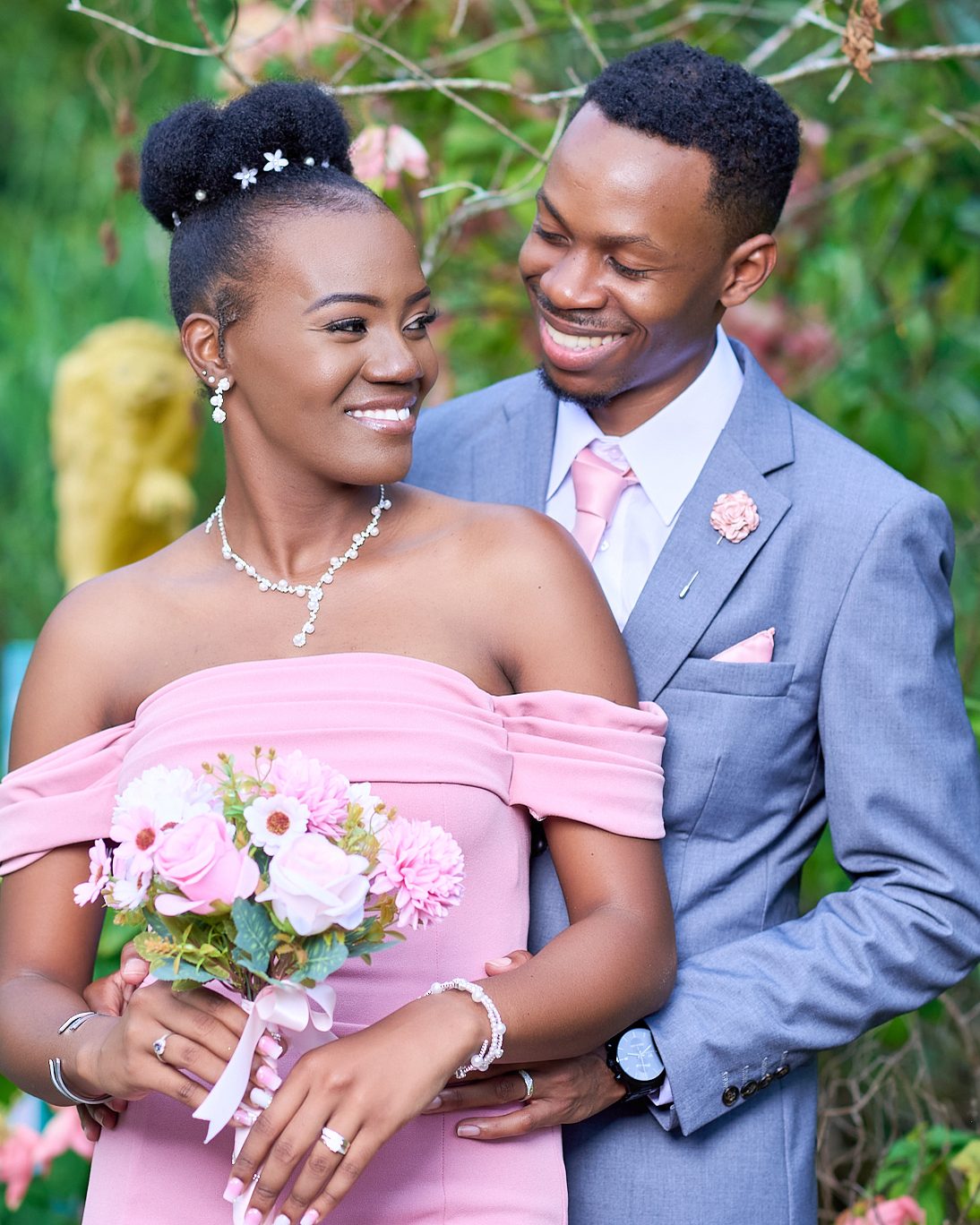 A couple laughing together in a flowering garden